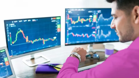 Image of man in office looking at watch