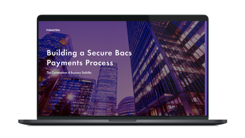 Image of laptop with cover slider of "Building a secure Bacs payments process: The cornerstone of business stability" eBook
