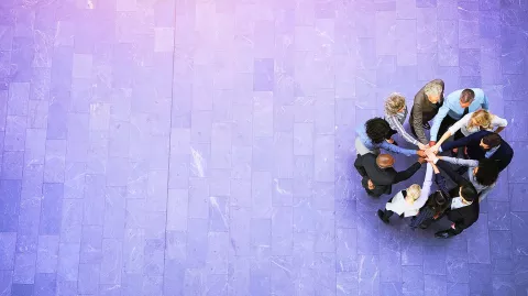 Image of team doing a hand-stack