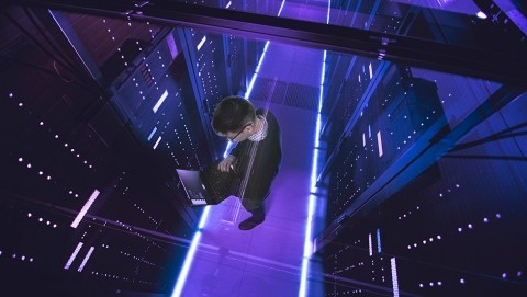 Image of young boy looking at his laptop in the servers room