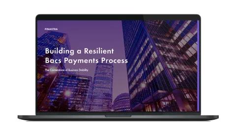 Image of laptop with cover slider of "Building a resilient Bacs payments process: The cornerstone of business stability" eBook