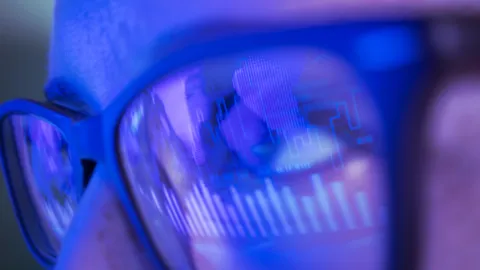 Closeup image of eyes with eyeglasses reflecting ghrapics
