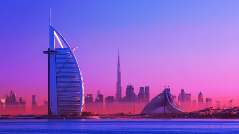 Dubai skyline at sunset with iconic Burj Al Arab and Burj Khalifa