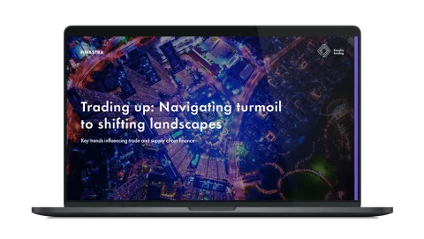 Image of laptop with cover slide of "Trading up: Navigating turmoil to shifting landscapes" white paper