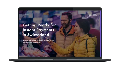 Image of laptop with cover slide of "Getting Ready for Instant Payments in Switzerland" ebook