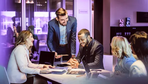 Modern business meeting with professionals collaborating in a corporate office.