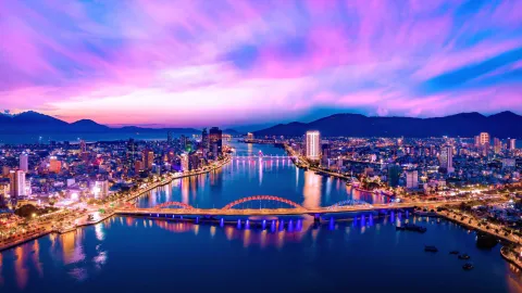 Modern cityscape with illuminated bridge and waterfront