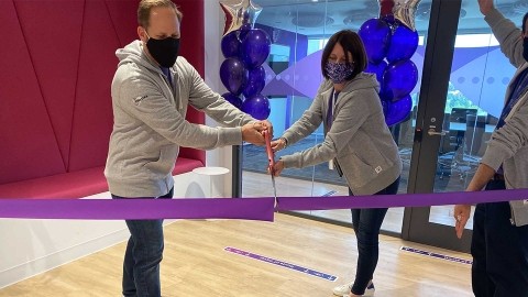 Two Finastra employees cutting ribbon