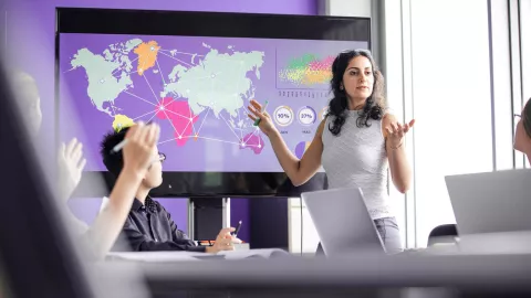Woman presenting on large screen