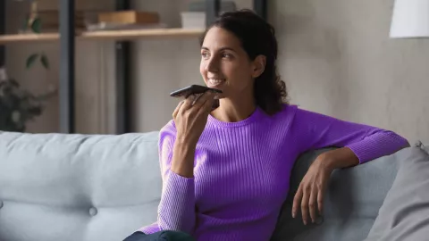 Woman on sofa talking on phone