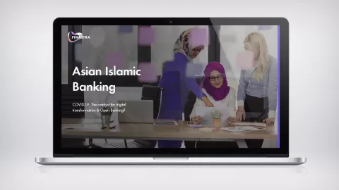 Image of laptop with 3 women at desk pointing to paper