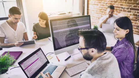 Team looking at code